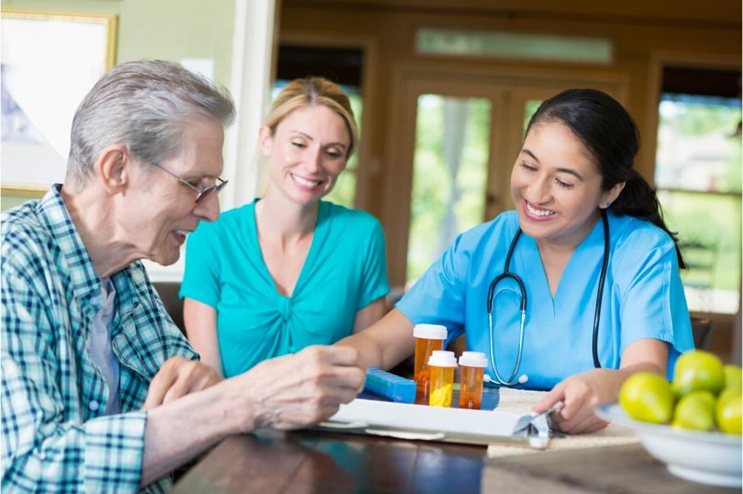 A care worker helping an older person take their prescribed medication safely at home